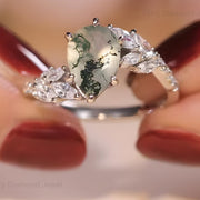 Pear moss agate engagement ring with leaf design in 14K white gold bridal band