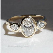 Oval Pear Moissanite trilogy ring in modern 14K gold with oval center stone and pear side stones