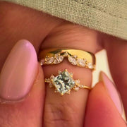 Princess cut moissanite bridal ring set in 14K yellow gold with accent stones and notch band