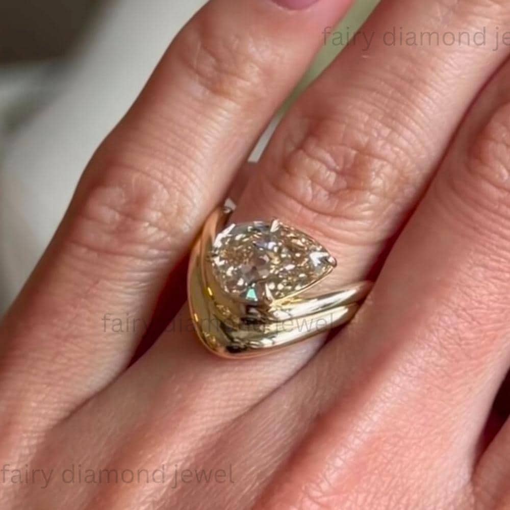 3ct Pear Moissanite Ring: 14k Yellow Gold Curved Chevron Band